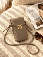 Women's lock closure passport crossbody bag with adjustable strap available in four colors