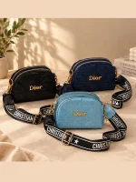 Women's Dior mini shoulder bag with quilted diamond stitching, gold-tone details, and wide printed strap in black, blue, and navy