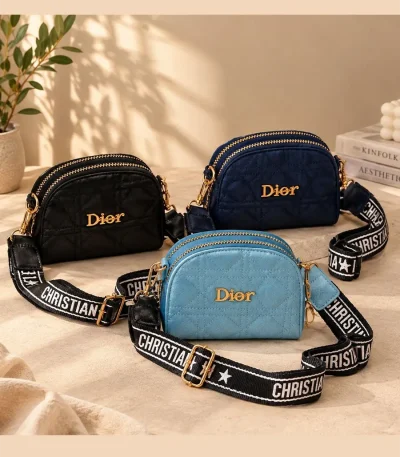 Women's Dior mini shoulder bag with quilted diamond stitching, gold-tone details, and wide printed strap in black, blue, and navy