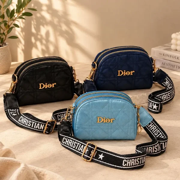 Women's Dior mini shoulder bag with quilted diamond stitching, gold-tone details, and wide printed strap in black, blue, and navy
