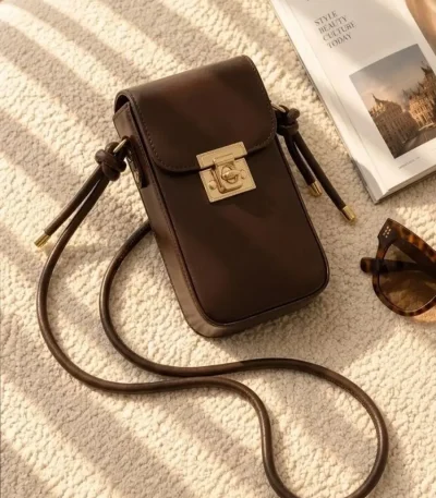 Women's lock closure passport crossbody bag with adjustable strap available in four colors