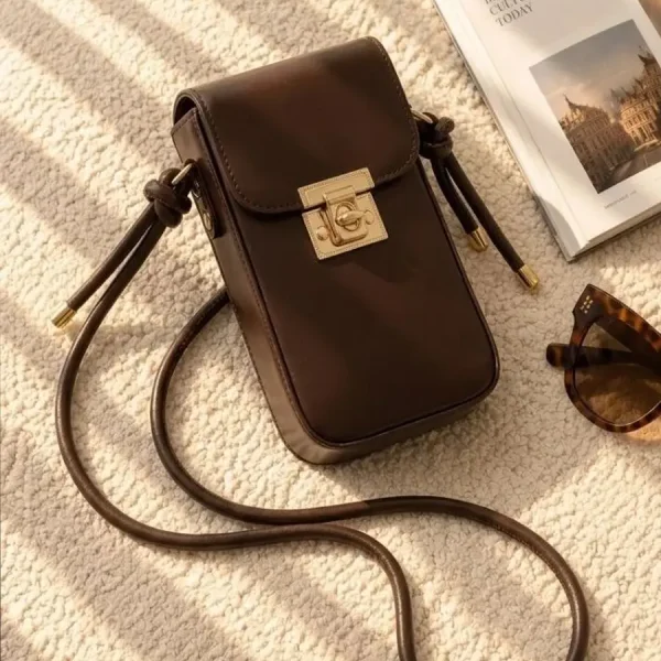 Women's lock closure passport crossbody bag with adjustable strap available in four colors