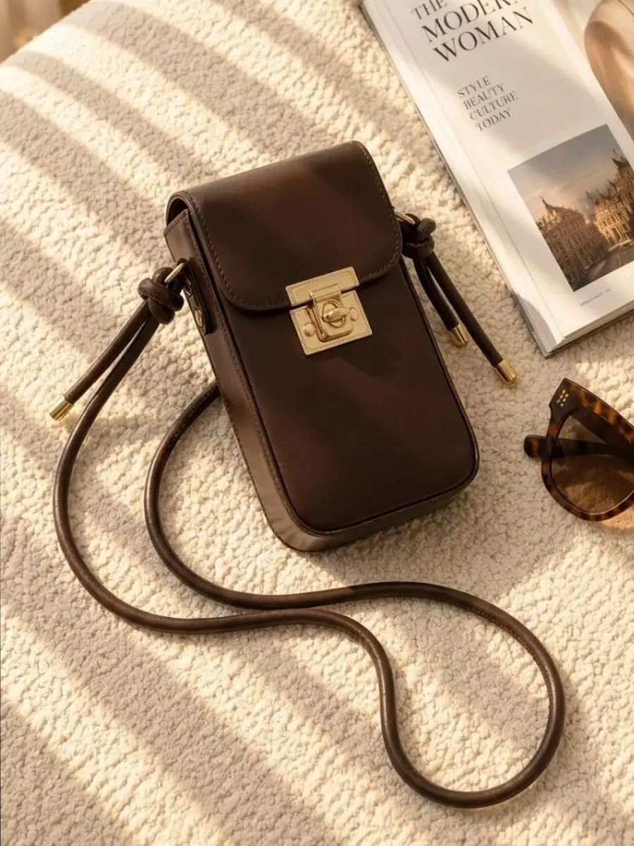 2 Women's lock closure passport crossbody bag with adjustable strap available in four colors