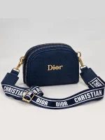 Navy women's Dior mini bag with diamond quilting, gold-tone details, and wide printed strap
