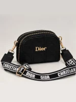 Black women's Dior mini bag with diamond quilting, gold-tone details, and wide printed strap