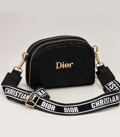 Black women's Dior mini bag with diamond quilting, gold-tone details, and wide printed strap