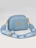 Blue women's Dior mini bag with diamond quilting, gold-tone details, and wide printed strap